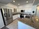Modern kitchen boasts stainless steel appliances and granite countertops with white cabinets at 1725 Queen Victoria St # 103, Las Vegas, NV 89144