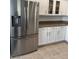 Kitchen featuring stainless steel refrigerator, granite counters, and white cabinets at 1725 Queen Victoria St # 103, Las Vegas, NV 89144