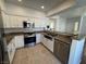 Well-equipped kitchen features stainless appliances, stone countertops, and a double sink at 1725 Queen Victoria St # 103, Las Vegas, NV 89144