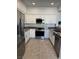 Kitchen with stainless steel appliances, granite countertops, and a modern backsplash at 1725 Queen Victoria St # 103, Las Vegas, NV 89144