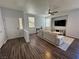 The living room features a neutral color palette, ceiling fan and hardwood floors at 1725 Queen Victoria St # 103, Las Vegas, NV 89144