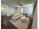 Bright living room features modern decor, a ceiling fan, and wood-style flooring at 1725 Queen Victoria St # 103, Las Vegas, NV 89144