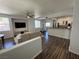 Spacious living room with modern furnishings and dark wood vinyl flooring at 1725 Queen Victoria St # 103, Las Vegas, NV 89144
