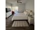 Bedroom featuring ceiling fan, balcony access and comfortable king bed at 1725 Queen Victoria St # 103, Las Vegas, NV 89144
