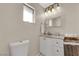 Bright bathroom featuring neutral walls, a modern toilet, and a basket for storage at 1813 Constantine Ave, Las Vegas, NV 89101