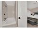 Bright bathroom featuring a tub with tiled walls and a view into a bedroom at 1813 Constantine Ave, Las Vegas, NV 89101