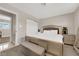 Bright bedroom featuring plantation shutters, a tufted headboard, and neutral colored walls at 1813 Constantine Ave, Las Vegas, NV 89101