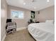 Bright bedroom featuring a window with plantation shutters, a computer, and neutral colored walls at 1813 Constantine Ave, Las Vegas, NV 89101