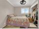 Cozy bedroom with a closet, a window with plantation shutters, and a floral patterned comforter at 1813 Constantine Ave, Las Vegas, NV 89101