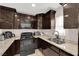 Modern kitchen featuring dark cabinets, tile floors, and stainless steel appliances at 1813 Constantine Ave, Las Vegas, NV 89101