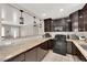 Modern kitchen featuring dark cabinets, tile floors, and stainless steel appliances at 1813 Constantine Ave, Las Vegas, NV 89101