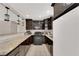 Modern kitchen featuring dark cabinets, tile floors, and stainless steel appliances at 1813 Constantine Ave, Las Vegas, NV 89101