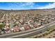 Vast neighborhood captured from above, showcasing rooftops and desert landscape reaching toward distant mountains at 182 Horizon View Dr, Henderson, NV 89015