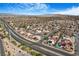 Expansive aerial view of a residential community with mountain views and nearby highway access at 182 Horizon View Dr, Henderson, NV 89015