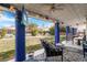 Inviting covered patio with blue pillars, offering views of the well-maintained backyard at 182 Horizon View Dr, Henderson, NV 89015