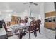 Open-concept dining room with marble floors, chandelier, and modern kitchen in background at 182 Horizon View Dr, Henderson, NV 89015