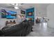 Spacious living room with white marble floors, large TV, and leather sofas at 182 Horizon View Dr, Henderson, NV 89015
