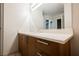 Clean bathroom with a modern single sink vanity, a stone countertop, and a large mirror at 200 W Sahara Ave # 1810, Las Vegas, NV 89102