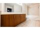 Modern bathroom featuring wood cabinetry and a soaking tub at 200 W Sahara Ave # 1810, Las Vegas, NV 89102
