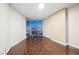 A modern bedroom with wood floors and a large window view of the city skyline at 200 W Sahara Ave # 1810, Las Vegas, NV 89102