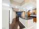 Stylish kitchen with an island, wood cabinets, and stainless steel appliances near the living space with city views at 200 W Sahara Ave # 1810, Las Vegas, NV 89102