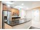 A well-lit kitchen with stainless steel appliances and granite countertops at 200 W Sahara Ave # 1810, Las Vegas, NV 89102