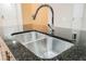 Modern kitchen with double stainless steel sinks and granite countertop at 200 W Sahara Ave # 1810, Las Vegas, NV 89102