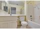 Bright bathroom with a white vanity, toilet, and a bathtub with shower at 2105 High Mesa Dr, Henderson, NV 89012