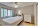 Cozy bedroom with hardwood floors, a ceiling fan, a bright window, and a storage closet at 2105 High Mesa Dr, Henderson, NV 89012