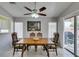 Bright dining area with large table, ceiling fan, and sliding door to patio space at 2105 High Mesa Dr, Henderson, NV 89012