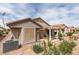 Rear view of the home showcasing the stucco exterior, patio cover, and desert landscaping at 2105 High Mesa Dr, Henderson, NV 89012