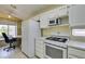 White kitchen features modern appliances and ample space, with an adjacent desk area for added functionality at 2105 High Mesa Dr, Henderson, NV 89012