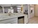 Open kitchen with white cabinets and stainless dishwasher, flows seamlessly into the adjacent living spaces at 2105 High Mesa Dr, Henderson, NV 89012