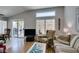 Comfortable living room with large windows, neutral walls, and access to backyard through sliding glass doors at 2105 High Mesa Dr, Henderson, NV 89012