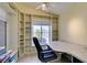 Office area with large window and custom built-in shelving is perfect for organization and productivity at 2105 High Mesa Dr, Henderson, NV 89012