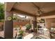 Relaxing covered patio area with ceiling fan, lounge seating, and desert landscaping in the yard at 2105 High Mesa Dr, Henderson, NV 89012