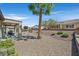Well-maintained backyard with desert landscaping, patio, and a seating area, perfect for relaxing at 2156 Shadow Canyon Dr, Henderson, NV 89044