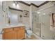 Cozy bathroom features wood cabinets, tile floors, and stand alone shower at 2156 Shadow Canyon Dr, Henderson, NV 89044