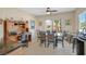 Bright breakfast nook with glass table, six chairs, and built in desk with backyard views at 2156 Shadow Canyon Dr, Henderson, NV 89044