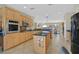 Spacious kitchen featuring stainless steel appliances, a kitchen island, and wooden cabinets at 2156 Shadow Canyon Dr, Henderson, NV 89044