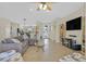 Open-concept living area with kitchen access, tile flooring, and stylish furnishings at 2156 Shadow Canyon Dr, Henderson, NV 89044