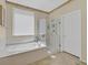 Bright main bathroom with soaking tub, stand alone shower, and tile floors at 2156 Shadow Canyon Dr, Henderson, NV 89044