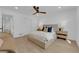 Bright bedroom with hardwood floors, neutral tones, stylish ceiling fan, and comfortable bed at 2160 Pueblo Cir, Las Vegas, NV 89169