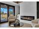 Contemporary living area with a sleek fireplace, balcony access, and tasteful decor for sophisticated living at 2160 Pueblo Cir, Las Vegas, NV 89169
