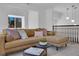 Cozy living room features a plush sectional sofa, modern lighting, and a view of the outdoors at 2160 Pueblo Cir, Las Vegas, NV 89169