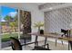 Office space with sliding glass doors that lead to green yard, stylish desk and chairs at 2160 Pueblo Cir, Las Vegas, NV 89169