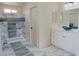 Bathroom featuring blue marble-look tile, a vanity and a step-in shower at 220 N David St, Pahrump, NV 89060