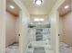 Bathroom with marble-look tile, a step-in shower, and access to the toilet room at 220 N David St, Pahrump, NV 89060