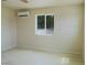 Bedroom with light hardwood floors, a mini-split system and a view of the outdoors at 220 N David St, Pahrump, NV 89060