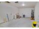 Spacious garage with concrete floors, access doors, and hookups for a washer and dryer at 220 N David St, Pahrump, NV 89060